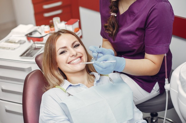 beautiful-girl-sitting-dentist-s-office_1157-23491